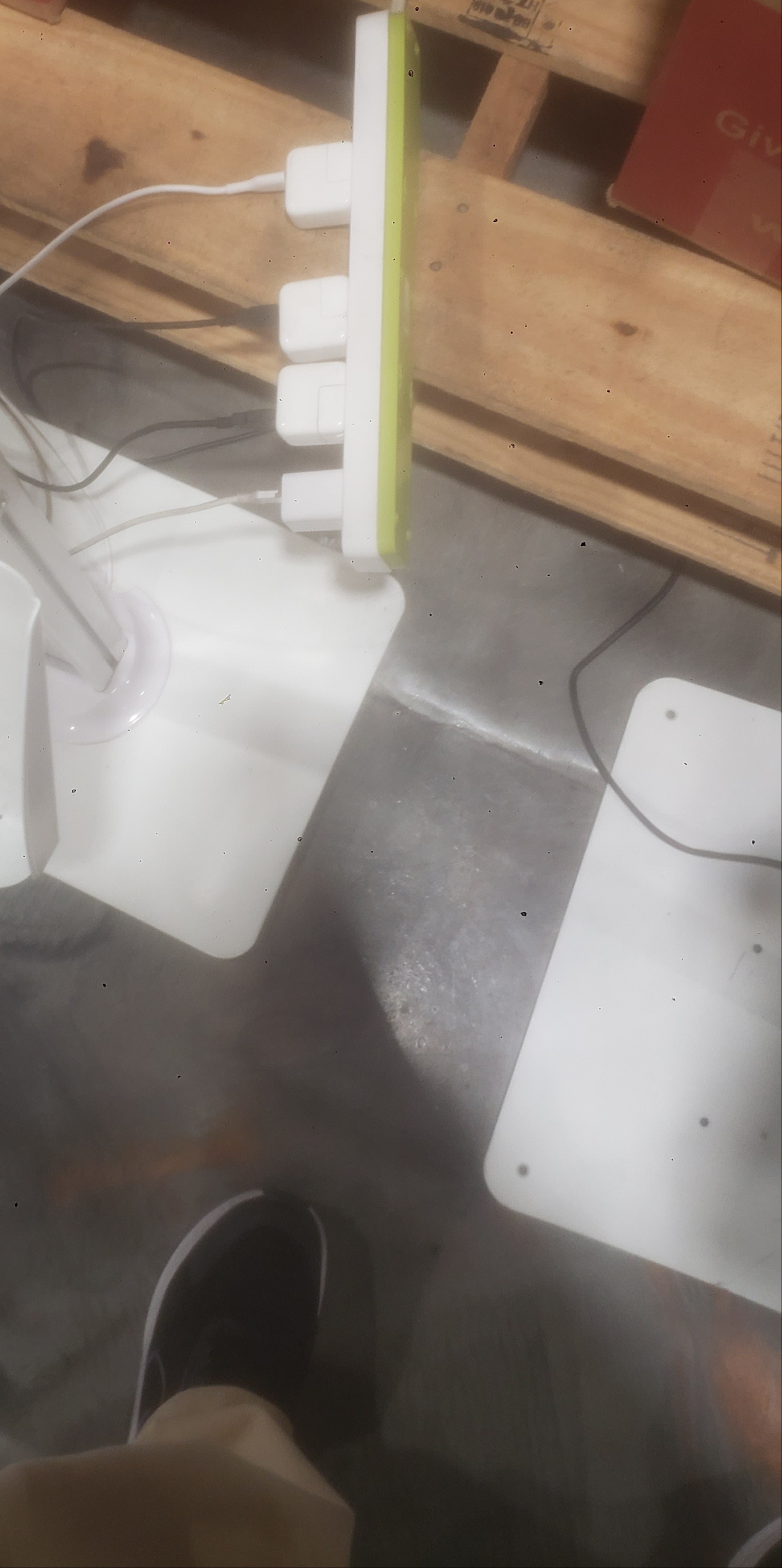 Green and white extension cord with plugged in ipad chargers.
